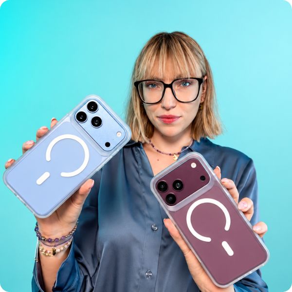 Kobieta prezentuje dwa przydymione, półprzezroczyste etui 3mk Hazy z MagSafe do iPhone 18 - na telefonach w kolorze jasnoniebieskim (glacier) i burgundowym, z widocznym pierścieniem magnetycznym